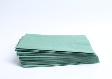 Photo of Many green paper handkerchiefs isolated on white