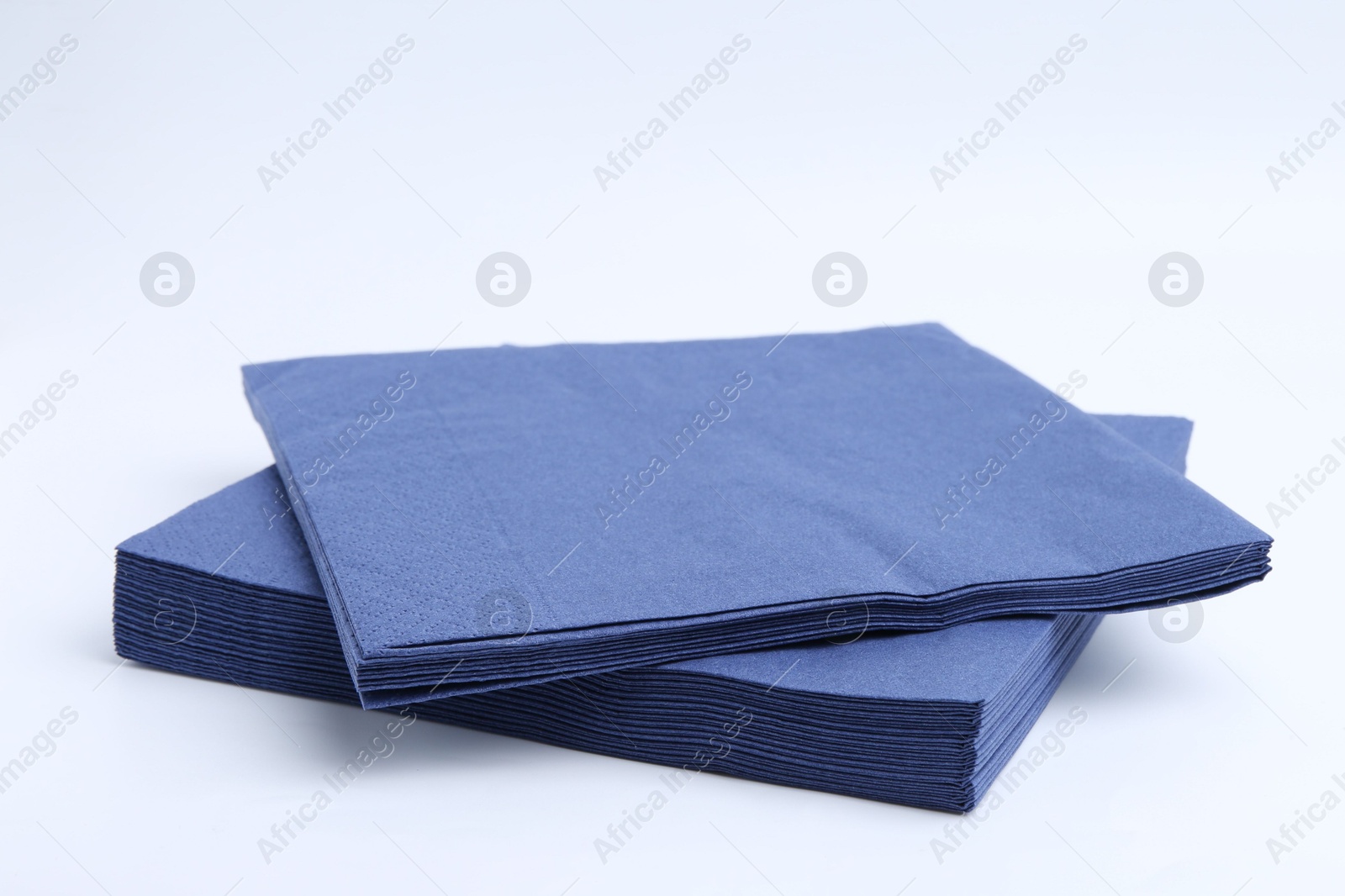Many blue paper handkerchiefs isolated on white Photo of Many blue paper handkerchiefs isolated on white