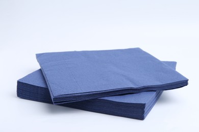 Photo of Many blue paper handkerchiefs isolated on white