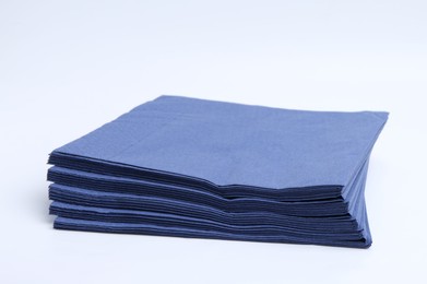 Photo of Many blue paper handkerchiefs isolated on white