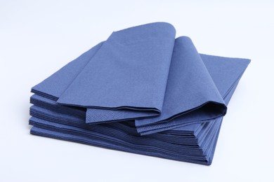 Photo of Many blue paper handkerchiefs isolated on white