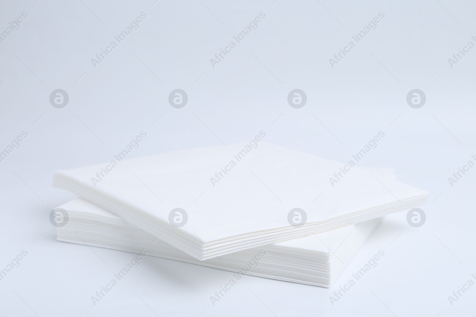 Stack of paper handkerchiefs isolated on white Photo of Stack of paper handkerchiefs isolated on white