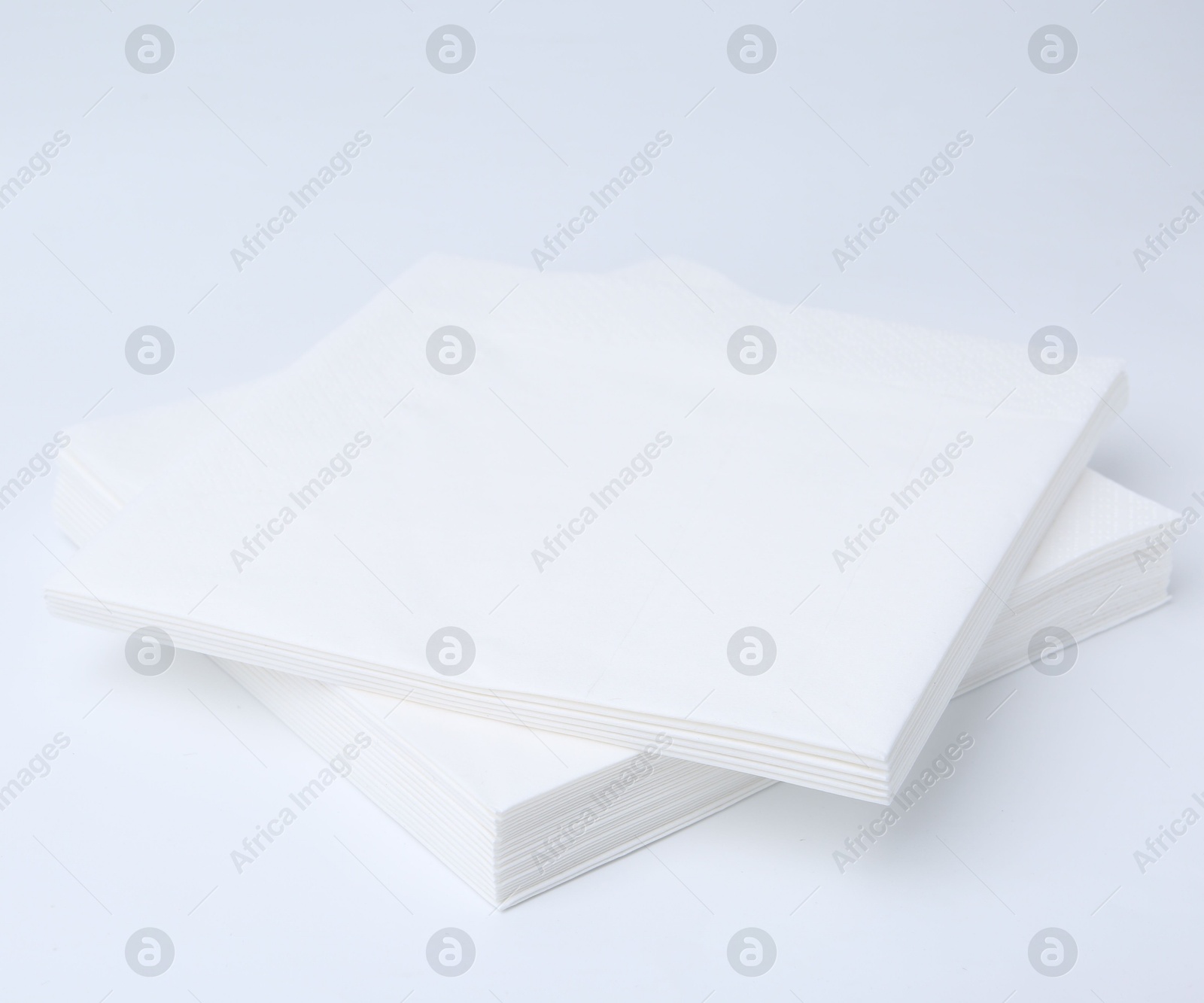 Stack of paper handkerchiefs isolated on white Photo of Stack of paper handkerchiefs isolated on white