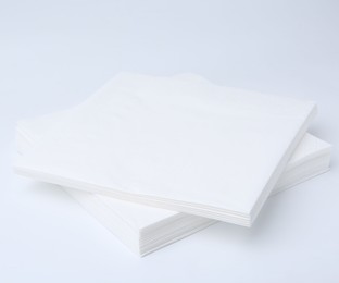 Photo of Stack of paper handkerchiefs isolated on white