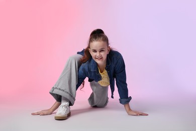 Photo of Girl in stylish clothes dancing on color background