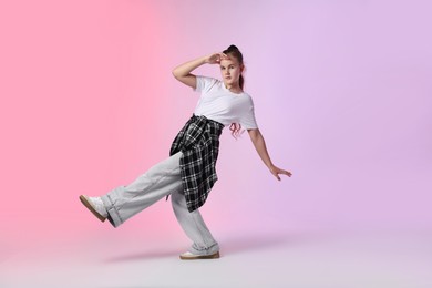 Photo of Girl in stylish clothes dancing on color background