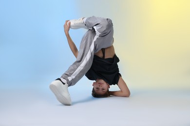 Photo of Boy in stylish clothes dancing on color background