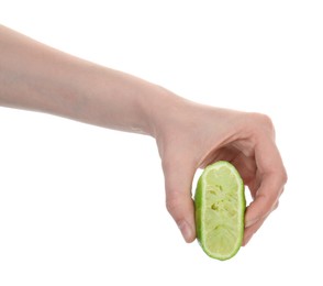 Photo of Woman squeezing lime on white background, closeup