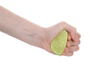 Photo of Woman squeezing lime on white background, closeup