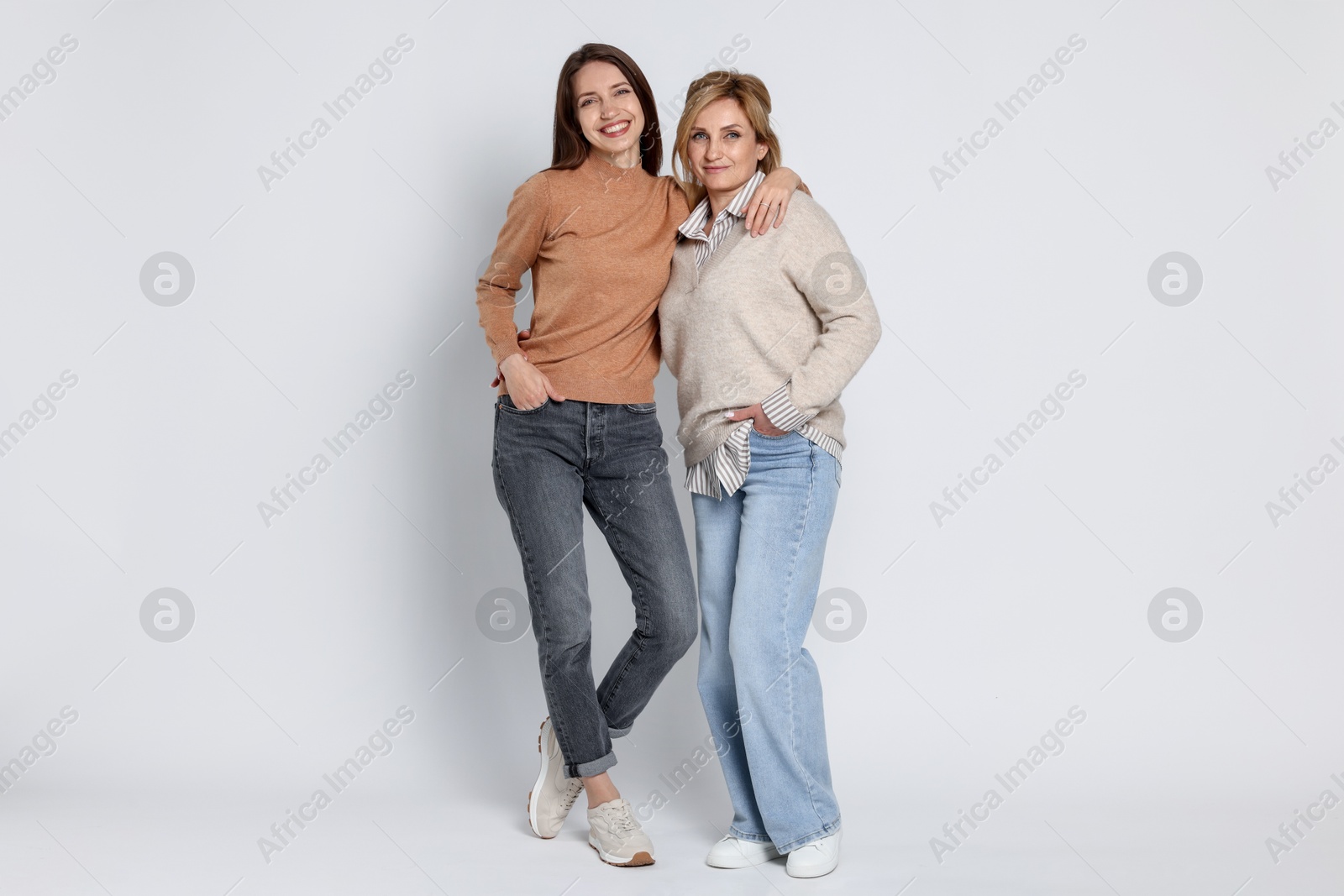 Photo of Beautiful mother and daughter on white background