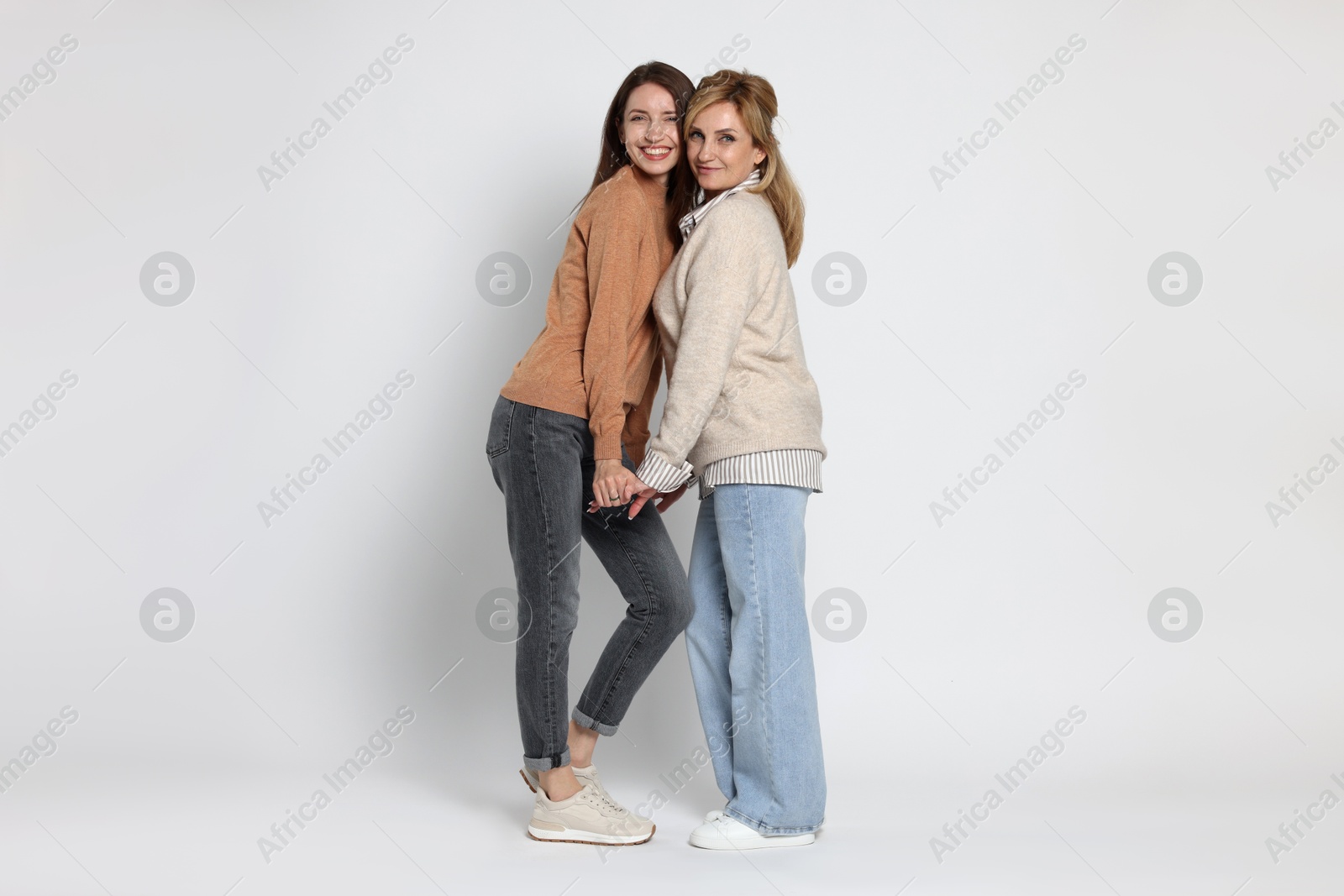 Photo of Beautiful mother and daughter on white background