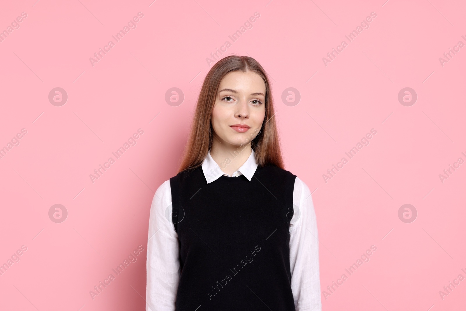 Photo of Portrait of teenage girl on light pink background