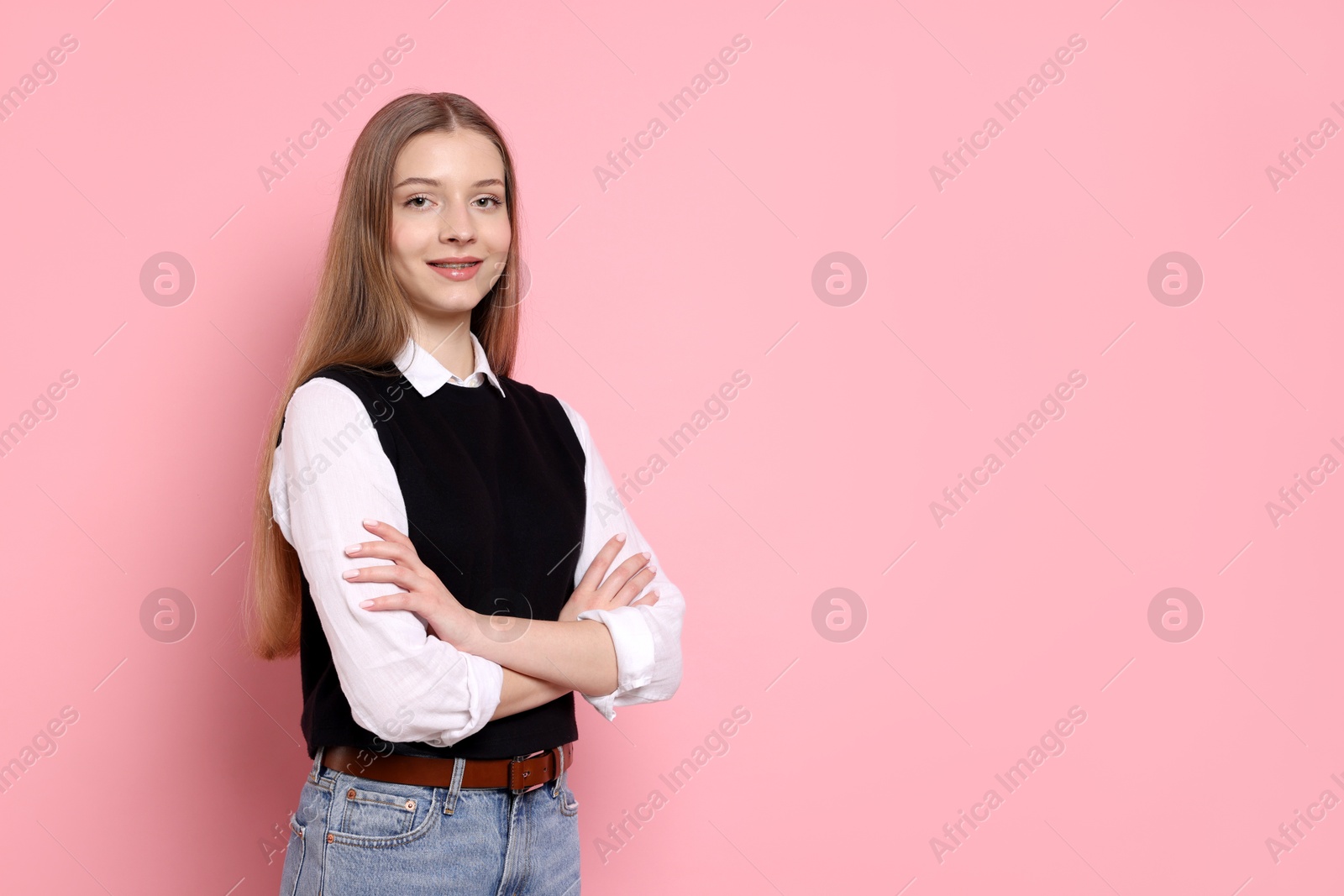 Photo of Portrait of teenage girl on light pink background. Space for text