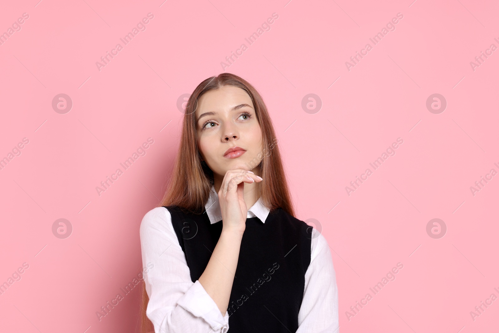 Photo of Pensive teenage girl on light pink background