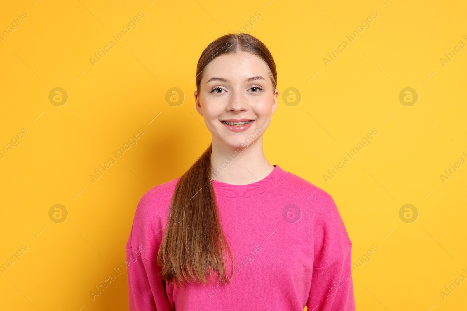 Photo of Portrait of teenage girl on yellow background