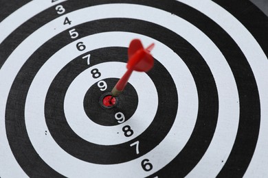 Photo of Targeting. Dart board with arrow, closeup view