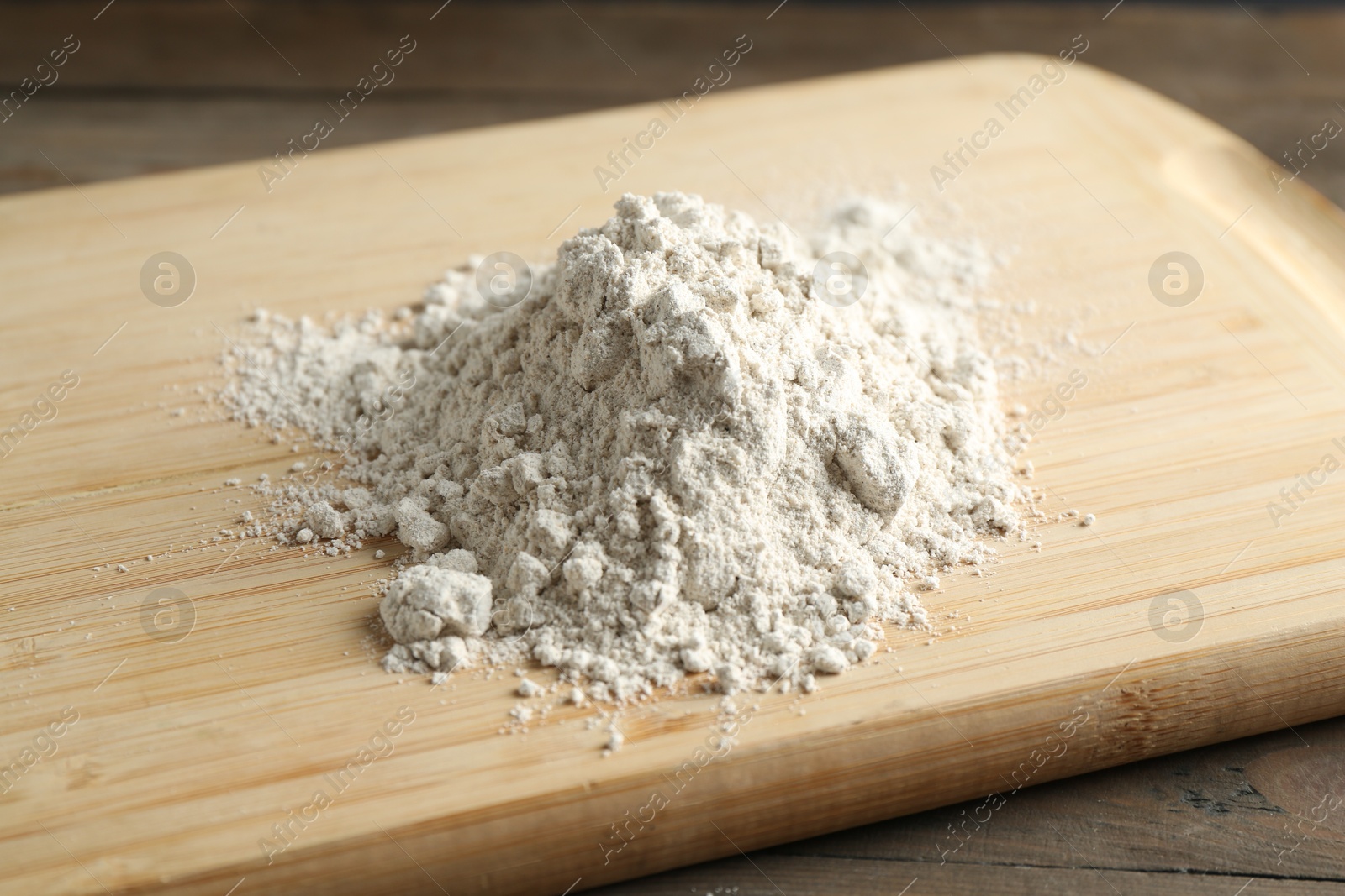 Pile of flour on wooden table, closeup Photo of Pile of flour on wooden table, closeup