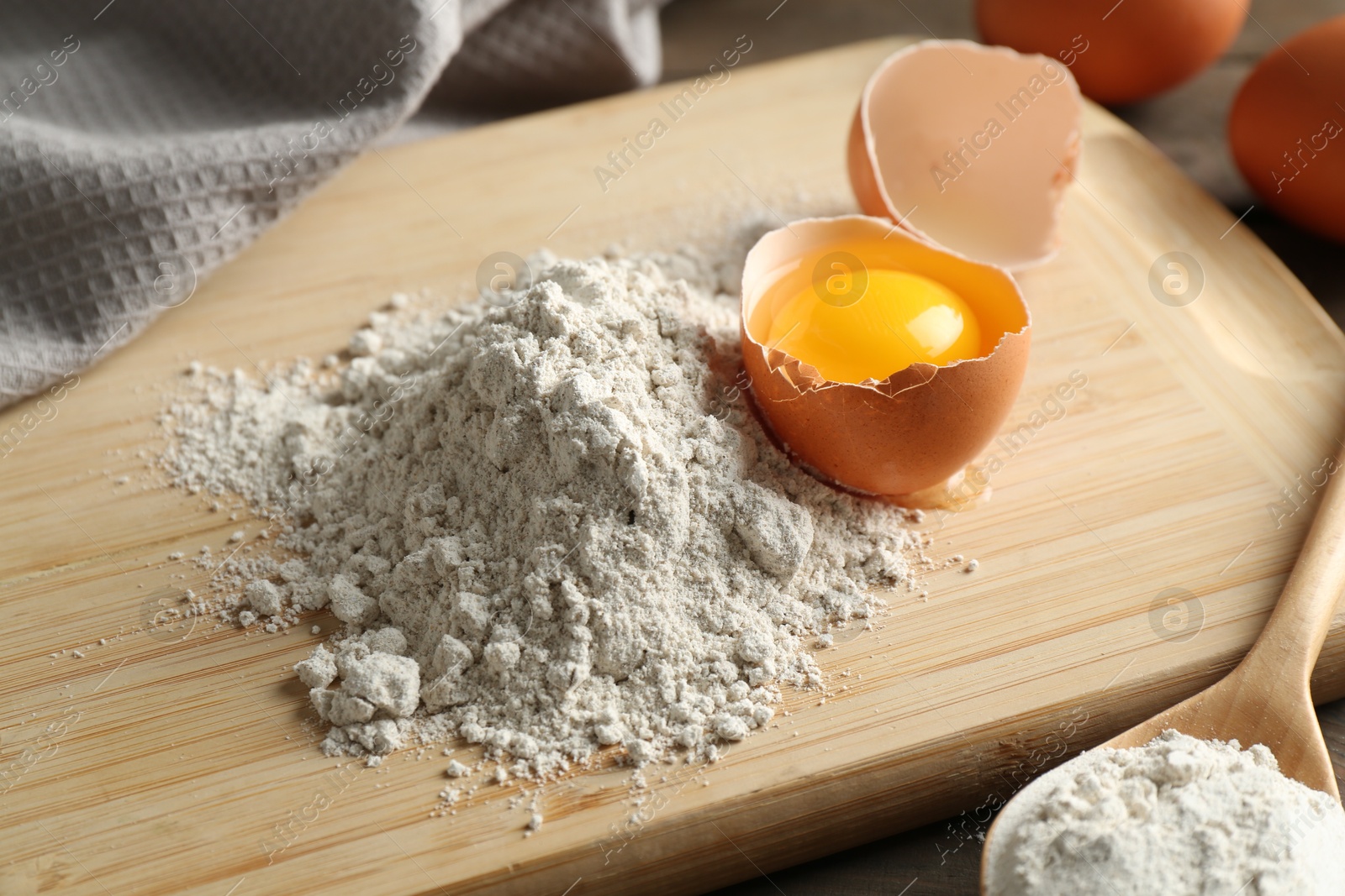 Pile of flour and broken egg on table, closeup Photo of Pile of flour and broken egg on table, closeup