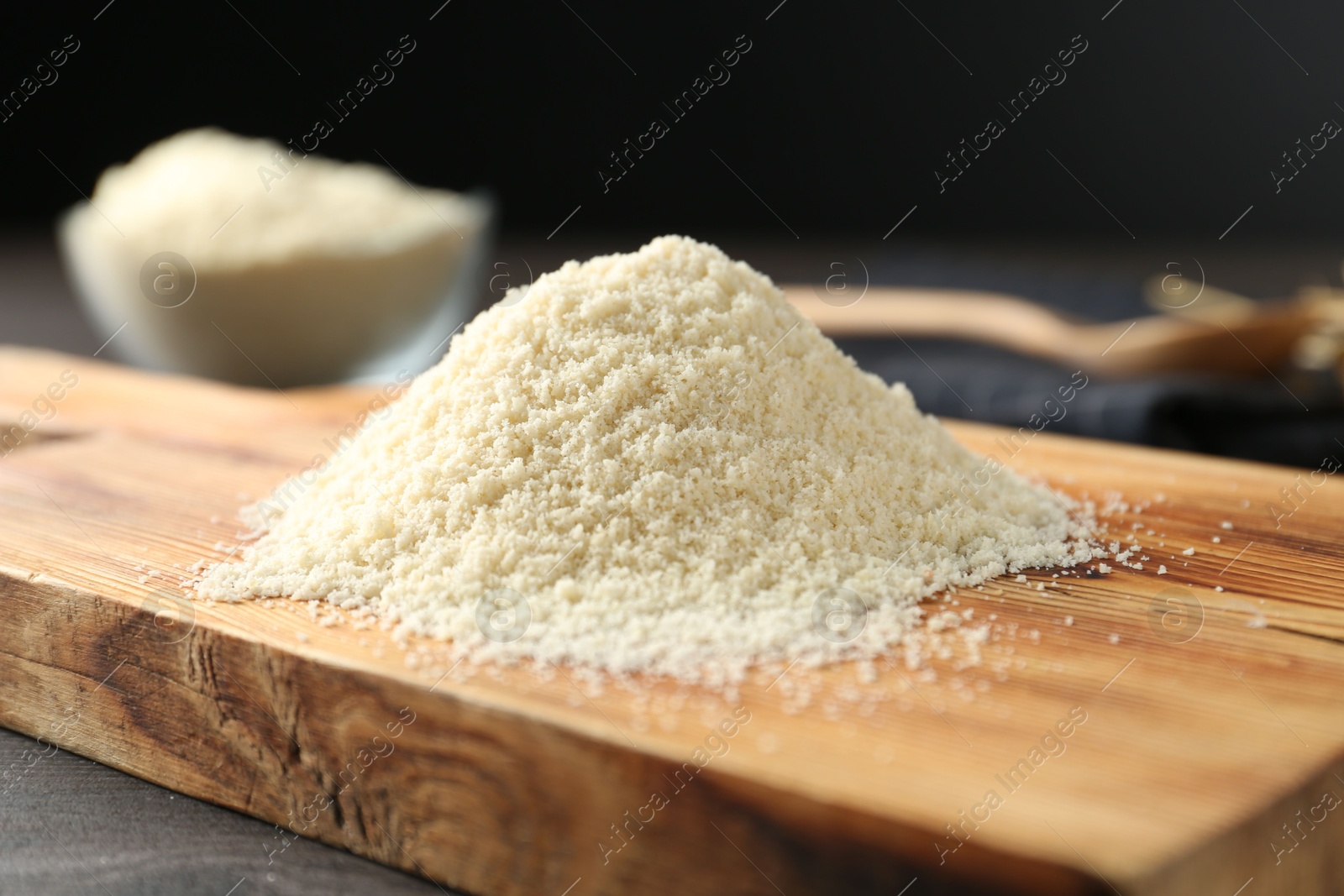 Pile of flour on dark wooden table against black background, closeup Photo of Pile of flour on dark wooden table against black background, closeup