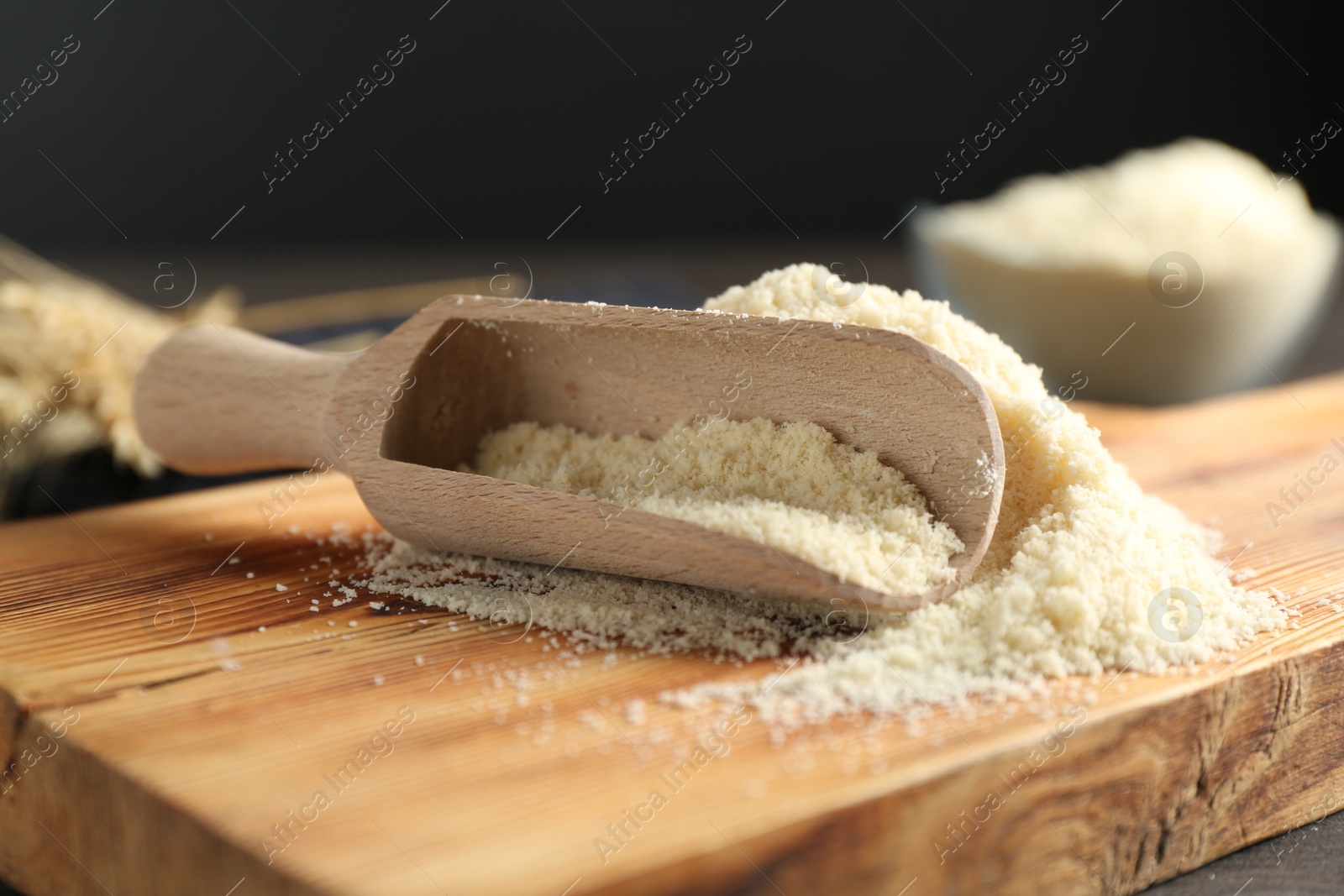 Pile of flour and scoop on dark wooden table against black background, closeup Photo of Pile of flour and scoop on dark wooden table against black background, closeup