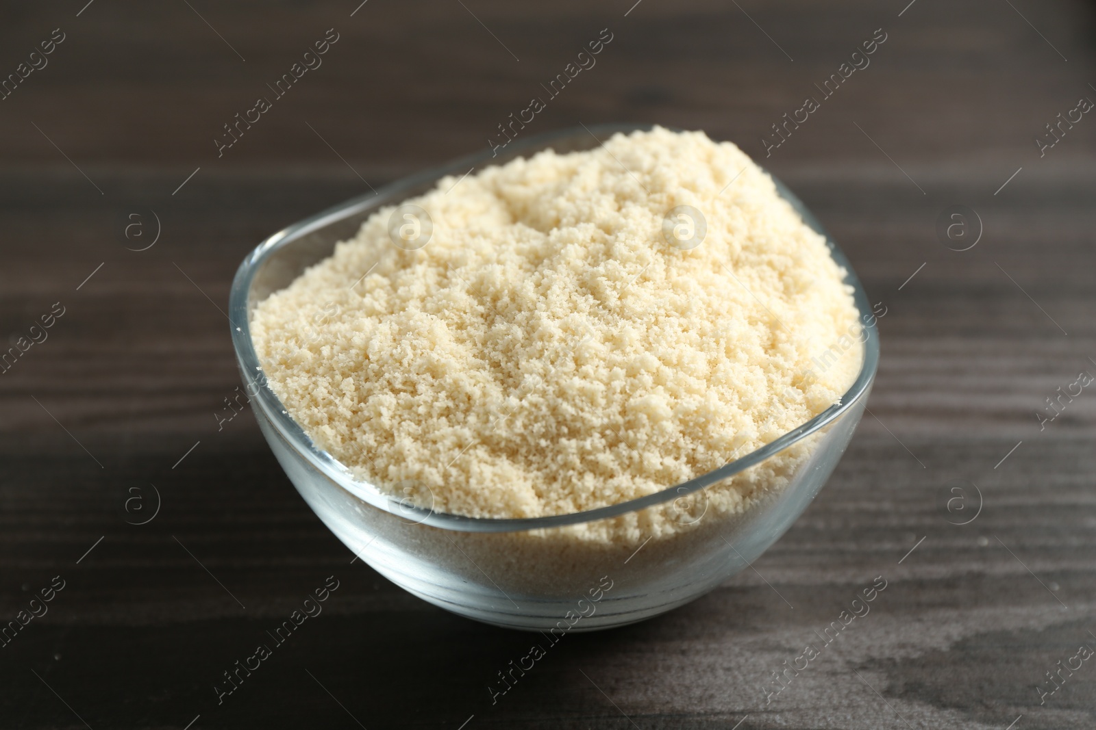 Flour in bowl on dark wooden table, closeup Photo of Flour in bowl on dark wooden table, closeup