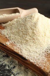 Photo of Pile of flour and scoop on table, closeup