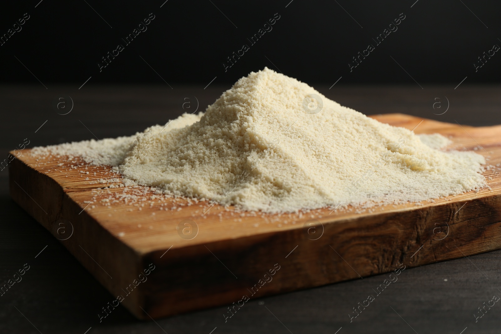 Pile of flour on dark wooden table against black background, closeup Photo of Pile of flour on dark wooden table against black background, closeup