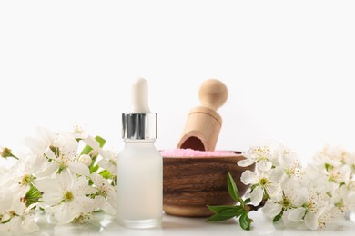 Photo of Spa composition with cosmetic products and beautiful flowers on white background, closeup
