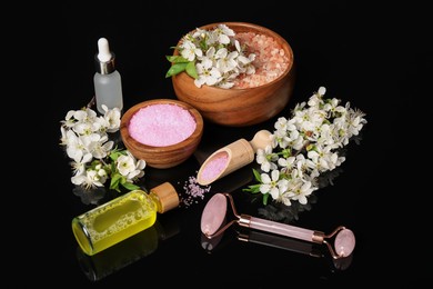 Photo of Spa composition with cosmetic products and beautiful flowers on black mirror surface