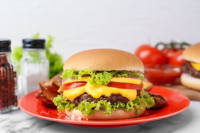 Photo of Tasty cheeseburger on white marble table, closeup