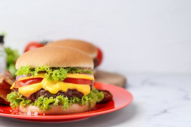 Photo of Tasty cheeseburger on white marble table, closeup. Space for text