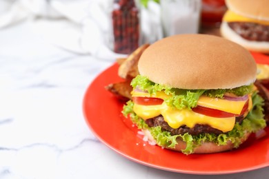 Photo of Tasty cheeseburger on white marble table, closeup. Space for text