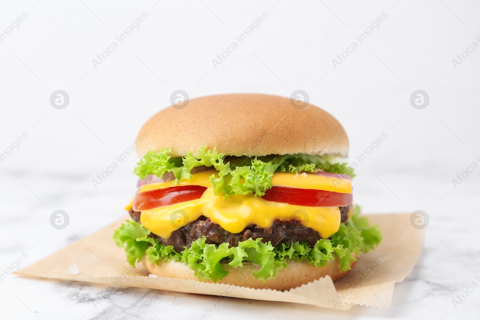Tasty cheeseburger on white marble table, closeup Photo of Tasty cheeseburger on white marble table, closeup