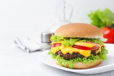 Photo of Tasty cheeseburger on white table, closeup. Space for text