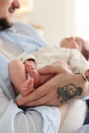 Photo of Father with his cute newborn baby indoors, closeup