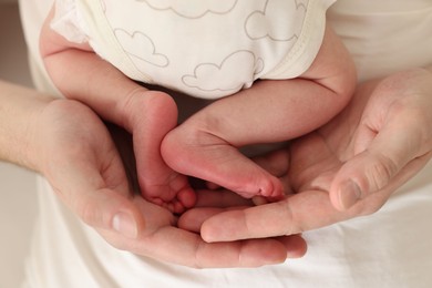 Photo of Father with his cute newborn baby indoors, closeup