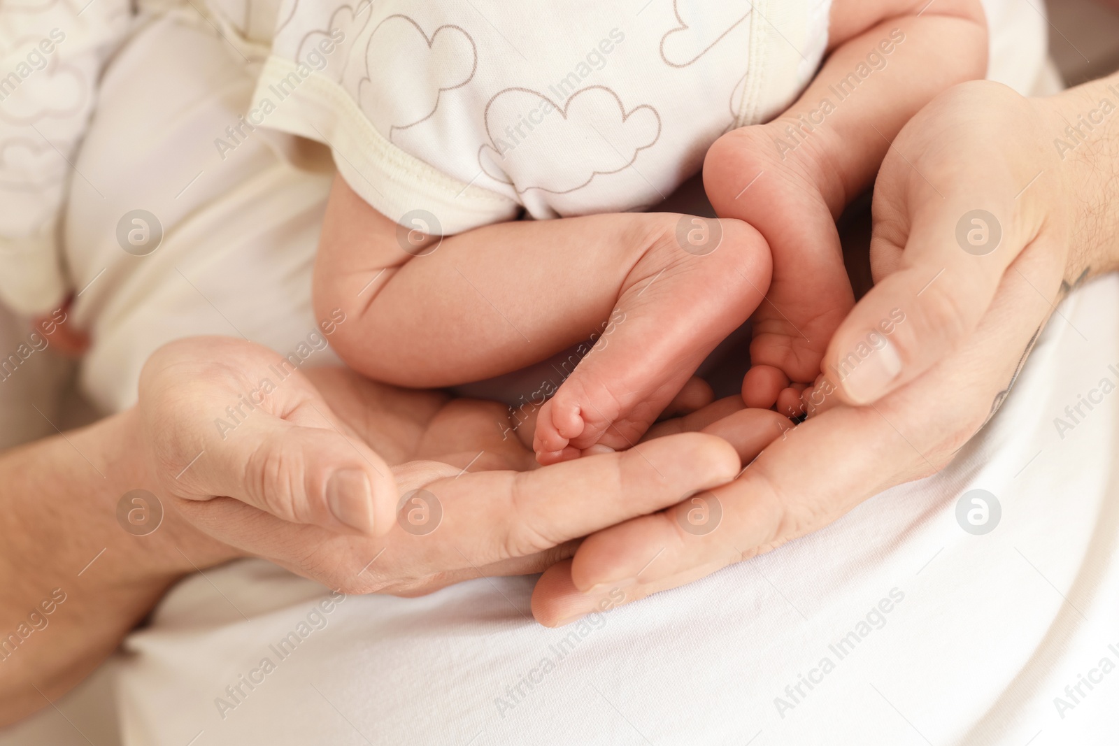 Father with his cute newborn baby indoors, closeup Photo of Father with his cute newborn baby indoors, closeup