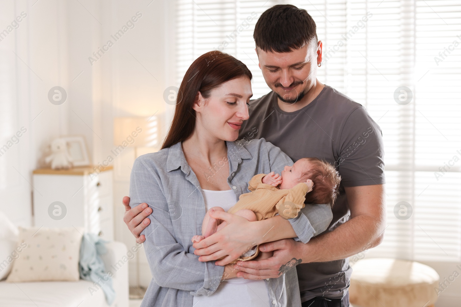 Happy parents with their cute newborn baby indoors Photo of Happy parents with their cute newborn baby indoors