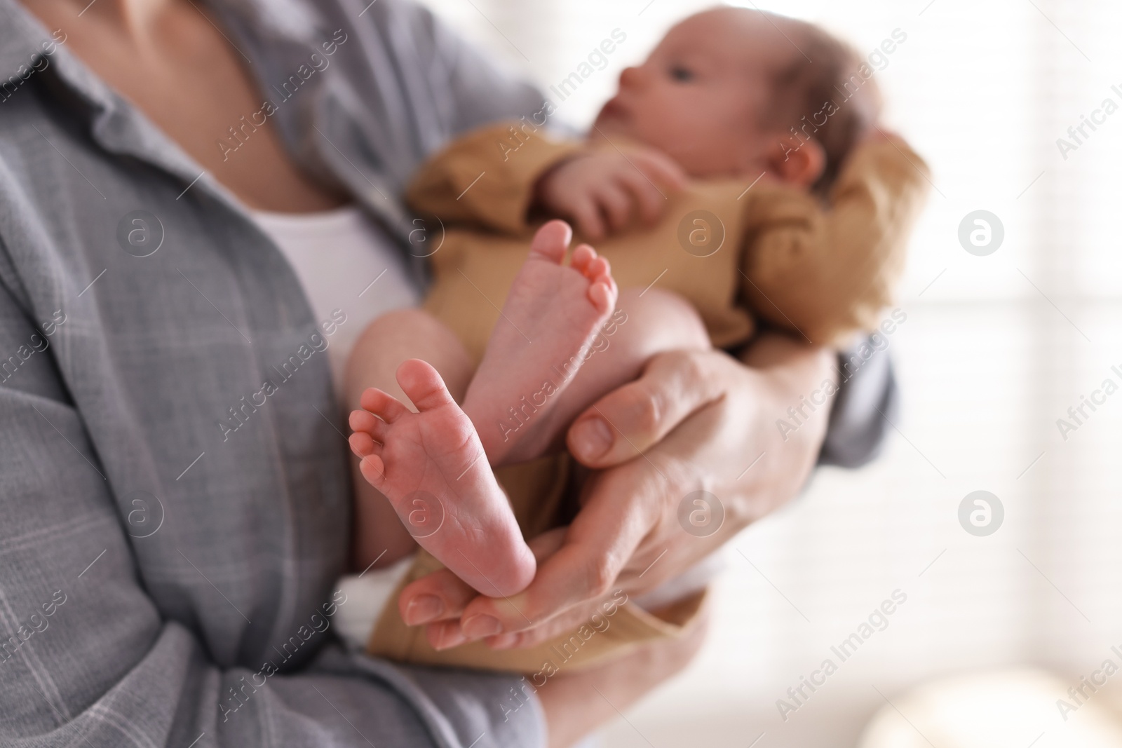 Mother with her cute newborn baby indoors, closeup Photo of Mother with her cute newborn baby indoors, closeup