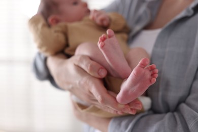 Photo of Mother with her cute newborn baby indoors, closeup