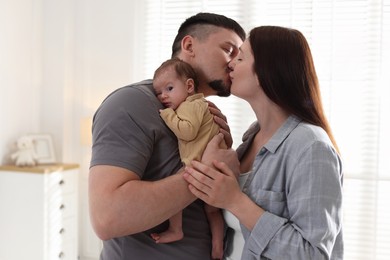 Photo of Parents with their cute newborn baby indoors