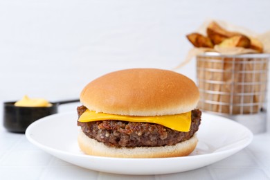 Photo of Cheeseburger with tasty patty on white table, closeup