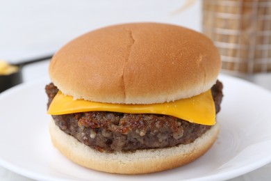 Photo of Cheeseburger with tasty patty on table, closeup