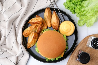 Photo of Tasty cheeseburger with sauce and potato wedges on white tiled table, flat lay