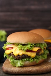 Photo of Tasty cheeseburger with sauce on table, closeup