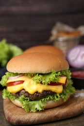 Photo of Tasty cheeseburger with sauce on table, closeup
