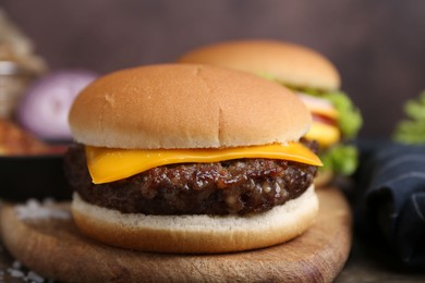 Photo of Cheeseburger with tasty patty on table, closeup