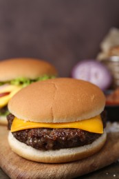 Photo of Tasty cheeseburgers served on table, closeup view