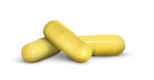 Image of Antibiotic pills. Yellow capsules on white background