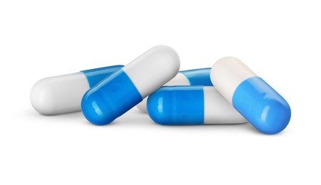 Image of Antibiotic pills. White and blue capsules on white background